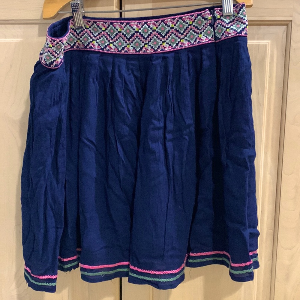Navy blue skirt with embroidered waistband. Size large.